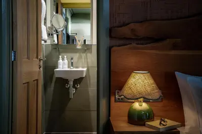 a bathroom with a sink and a lamp next to a door at Royal Oak at Keswick in Keswick