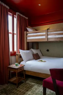 a bedroom with a bed and two bunk beds at Royal Oak at Keswick in Keswick