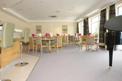 a dining room with a table and chairs at Ramsey Park Hotel in Ramsey