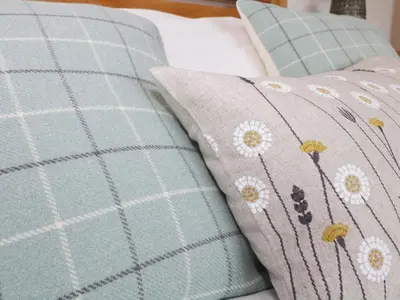 a couple of pillows sitting on a bed at Coney Garth Retreat in Beckermet