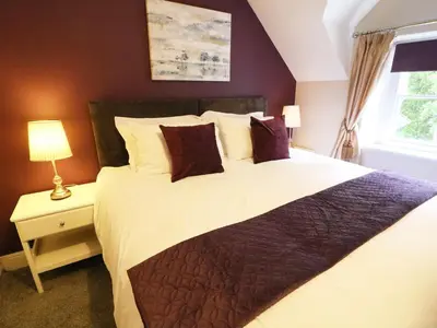 a bedroom with a large bed and a window at Shepherd's Crook in Ambleside