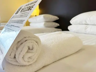 a pile of towels sitting on top of a bed at Buccleuch Arms Hotel in Moffat