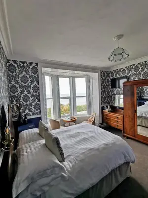 a bedroom with a large bed and a window at Westcliff in Seascale