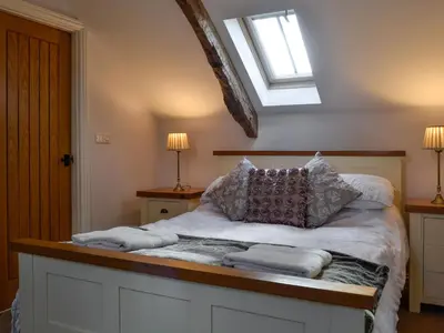 a bedroom with a bed with pillows on it at Swallow Barn in Torpenhow