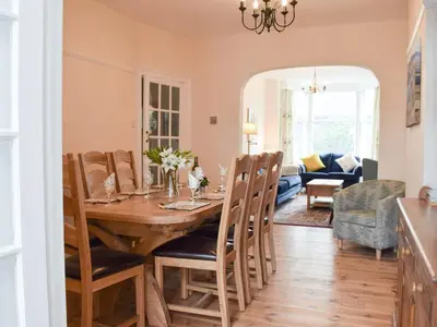 a dining room and living room with a table and chairs at Otterbield in Keswick