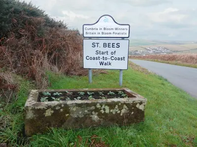 a sign on a road that says st bees start of coast to coast walk at The Byres Tan in St Bees