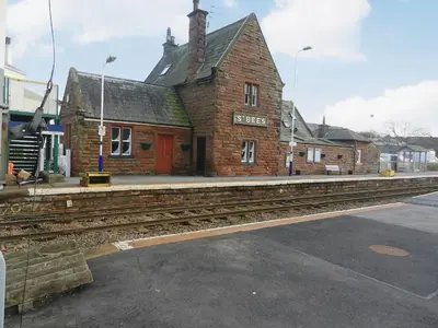 an old brick building with a train station at The Byres Tethera in St Bees