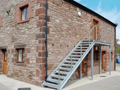 a staircase on the side of a brick building at The Byres Methera in St Bees