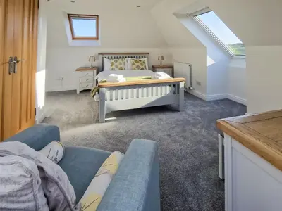 a bedroom with a bed and a couch at Gullsway in Glencaple