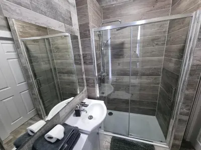 a bathroom with a shower and a sink and a toilet at Windsor house in Stranraer