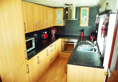 a kitchen with a sink and a microwave at Limestone Lodges in Bothel