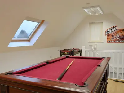 a room with a pool table in a attic at Hawthorn Cottage in Stranraer