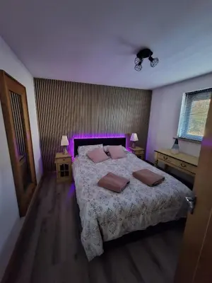 a bedroom with a bed with two pillows on it at Woodburn Lodges in Dumfries