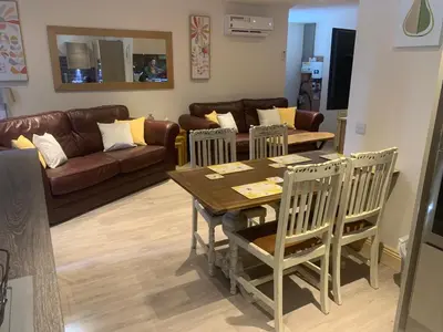 a living room with a table and chairs and a couch at Woodburn Lodges in Dumfries