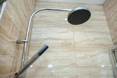 a shower with a shower head in a bathroom at Carlton 2 a large modern Keswick appt with parking in Keswick