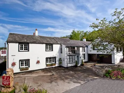 a large white house with a driveway at Littlebeck Warren in Whitehaven