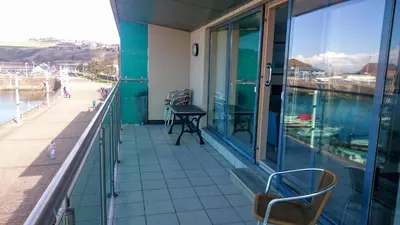 a balcony with a view of the water at Harbourside Apartment in Whitehaven
