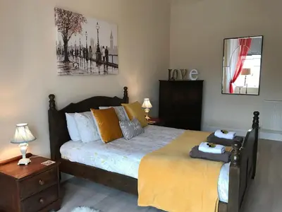 a bedroom with a large bed and a nightstand with a bed sidx sidx sidx at Home with a view in Moffat