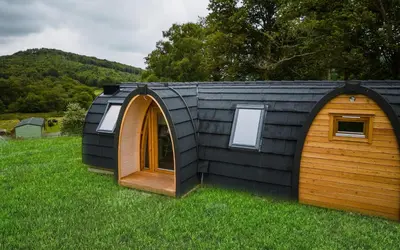 a small black igloo house in the grass at Parkgate Farm in Holmrook