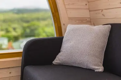 a pillow sitting on a chair in front of a window at Parkgate Farm in Holmrook
