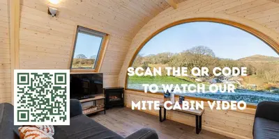 a room with a large window and a tv at Parkgate Farm in Holmrook