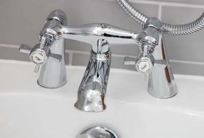a chrome bathroom faucet on a white sink at Maxwelston Farmhouse in Girvan