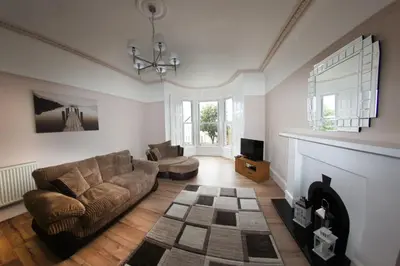 a living room with a couch and a fireplace at Ayr Beach View Apartment in Ayr