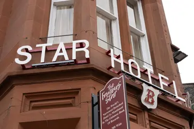 a sign on the side of a building with a stop sign at The Famous Star Hotel Moffat in Moffat