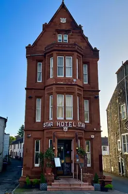 a red brick building with a star hotel sign on it at The Famous Star Hotel Moffat in Moffat