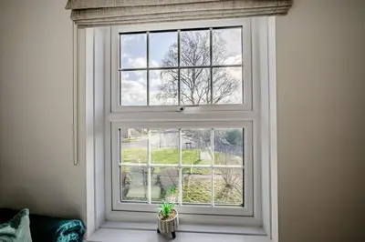 a window with a plant sitting in front of it at Cosy Apartment in Wetheral,Cumbria in Wetheral
