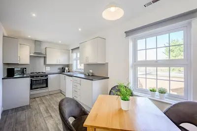 a kitchen with a table and chairs and a window at Cosy Apartment in Wetheral,Cumbria in Wetheral
