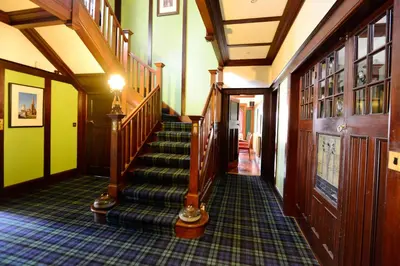 a hallway with a staircase in a house at Rivendell in Dumfries