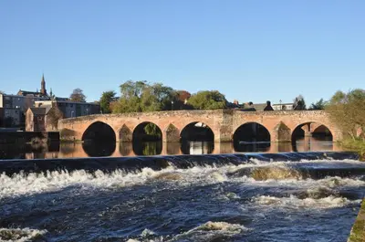 a bridge over a river with rushing water at Rivendell in Dumfries