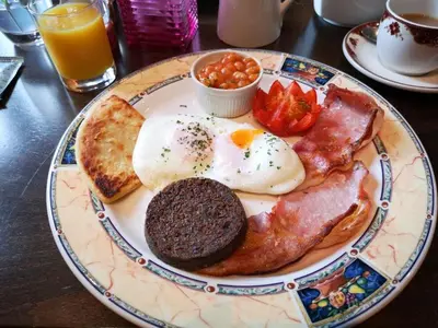 a plate of breakfast food with eggs bacon and toast at Rivendell in Dumfries