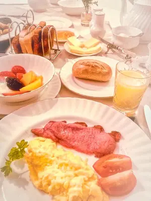 a table with plates of breakfast food on it at Bessiestown Country Guesthouse in Carlisle