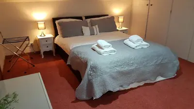 a bedroom with a bed with towels on it at Criffel Cottage in Dumfries