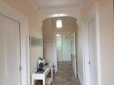 a hallway with a room with a table and a hallwayngthngthngthngthngth at Criffel Cottage in Dumfries