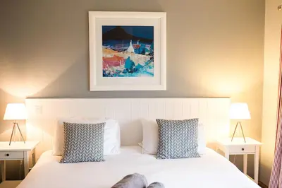 a bedroom with a bed with a painting above it at Galloway View in Castle Douglas