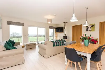 a living room with a table and a couch at Galloway View in Castle Douglas