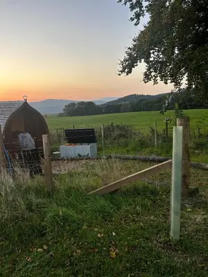 a yurt in a field with a fence and a field at Galloway View in Castle Douglas