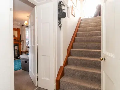 a stairway leading to a hallway with a stair case at Castle Lodge in Keswick