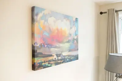 a painting of a house on a wall at Fleet View in Gatehouse of Fleet