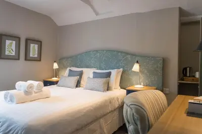 a bedroom with a large bed with towels on it at The Horse and Farrier Inn and The Salutation Inn Threlkeld Keswick in Threlkeld