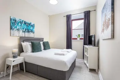 a bedroom with a bed and a window at Granary Suite No3 - Donnini Apartments in Ayr