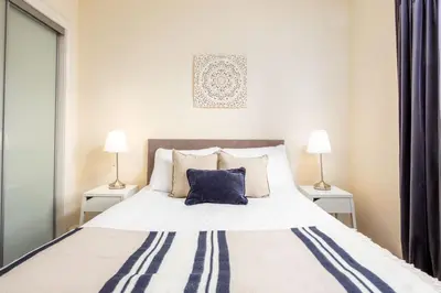 a bedroom with a large bed with two lamps at Elliot Suite No15 - Donnini Apartments in Ayr