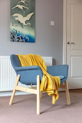 a blue chair with a yellow blanket on top of it at Elliot Suite No15 - Donnini Apartments in Ayr