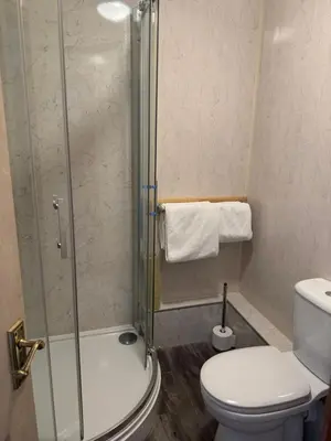 a bathroom with a shower and a toilet at Prince Charlie's Cottage in Gretna Green