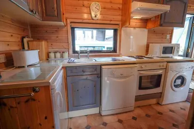 a kitchen with a sink and a stove top oven at Fellside Lodge in Keswick