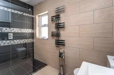 a bathroom with a shower and a sink at Isabel Cottage in Keswick