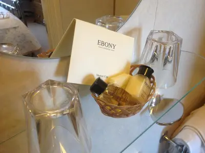 a glass table with a basket of cheese on it at Acorn House in Keswick